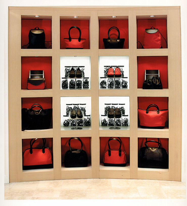 Window Display using grid of Hand Bags and shoes for Rockport shoes.  Clean, modern designs for retail spaces
